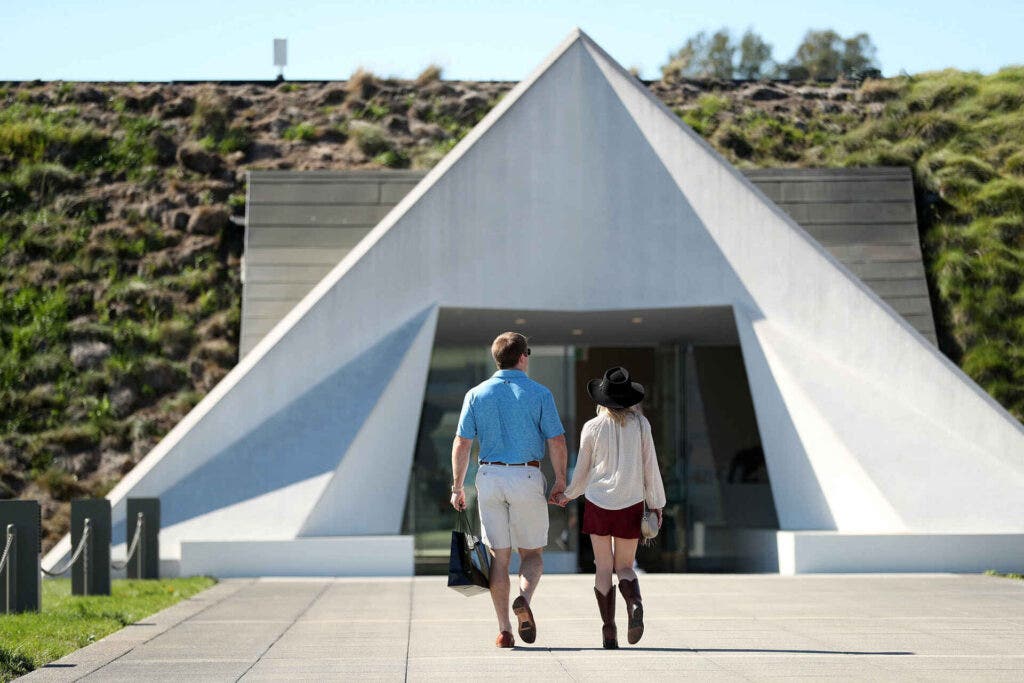 Visitors approach the entrance at Artesa Winery in Napa, Calif