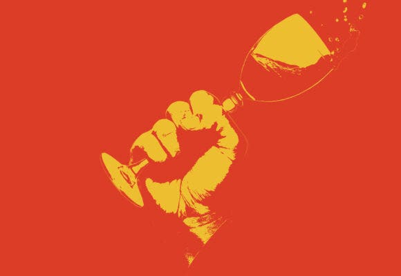 A fist holding a wine glass with a design treatment