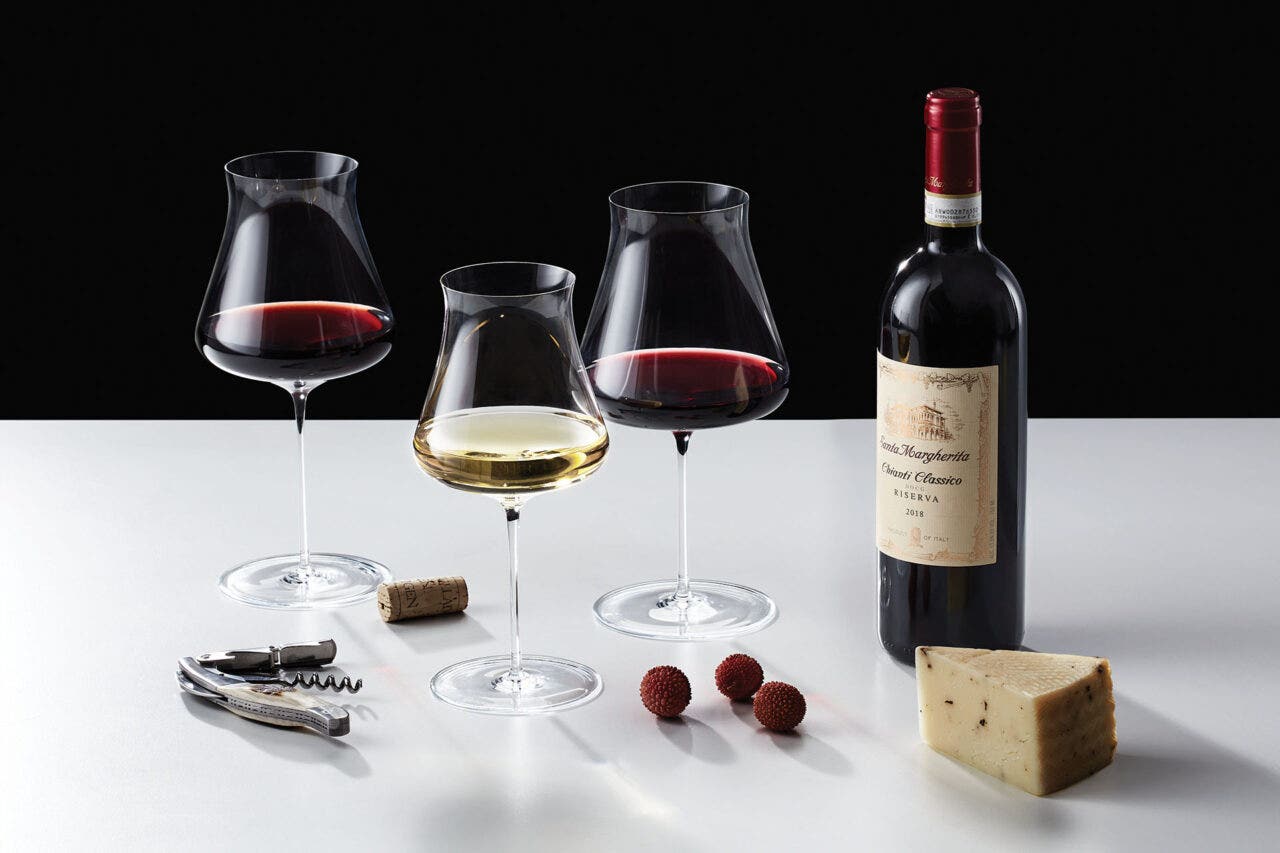 Wine Enthusiast wine glasses next to a bottle of wine and cheese